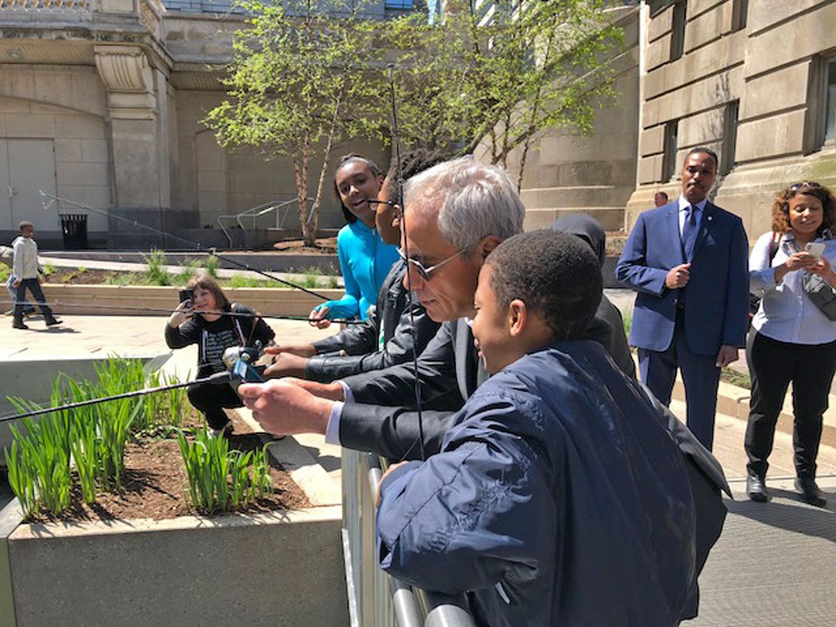 Mayor Rahm Emanuel joins some children fishing along the Chicago Riverwalk on Wednesday morning. | Fran Spielman/Sun-Times
