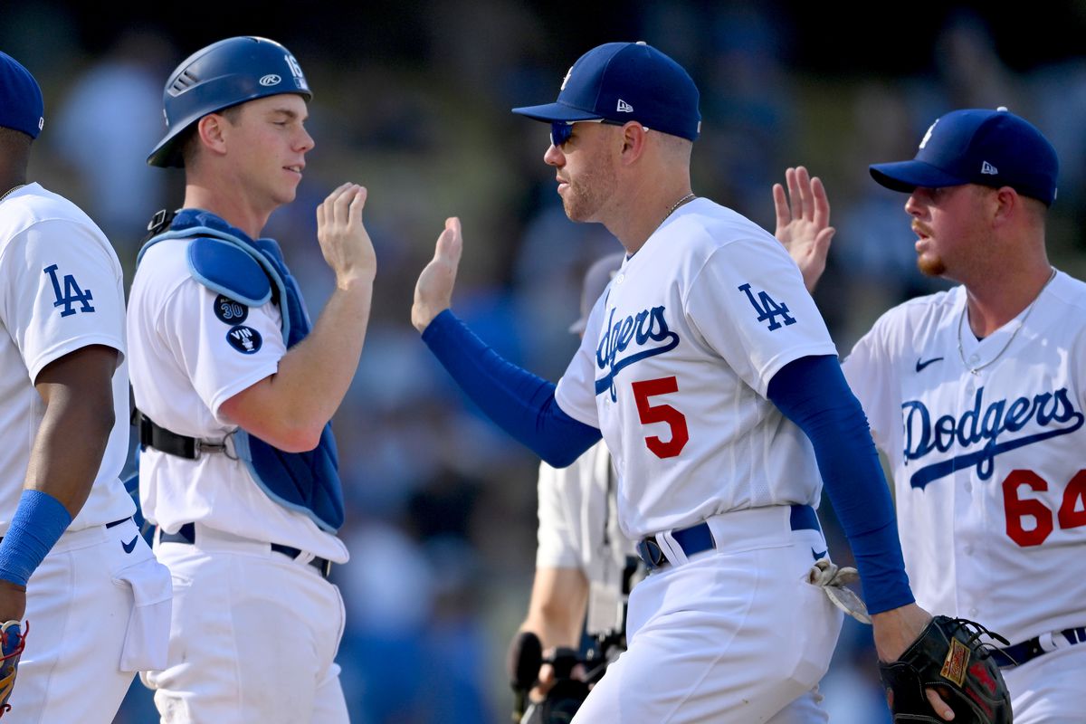 Los Angeles Dodgers catcher Will Smith (16) and first baseman Freddie Freeman (5) high five after the final out against the Colorado Rockies at Dodger Stadium. Mandatory Credit: Jayne Kamin-Oncea