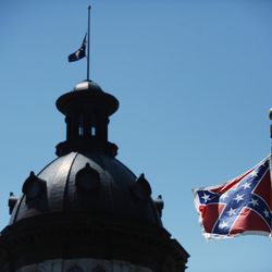 In a Friday, June 19, 2015 file photo, the Confederate flag flies near the South Carolina Statehouse, in Columbia, S.C. For 15 years, South Carolina lawmakers refused to consider removing the Confederate flag from Statehouse grounds, but opinions changed within five days of the massacre of nine people at Emanuel African Methodist Episcopal church in Charleston, as a growing tide of Republicans joined the call to remove the battle flag from a Confederate monument in front of the Statehouse and put it in a museum., File