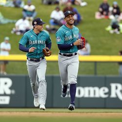 Sam Haggerty #0 and Julio Rodriguez #44 of the Seattle Mariners smile as they leave the field after the end of the third inning of a spring training game against the Chicago Cubs at Sloan Park on March 01, 2023 in Mesa, Arizona