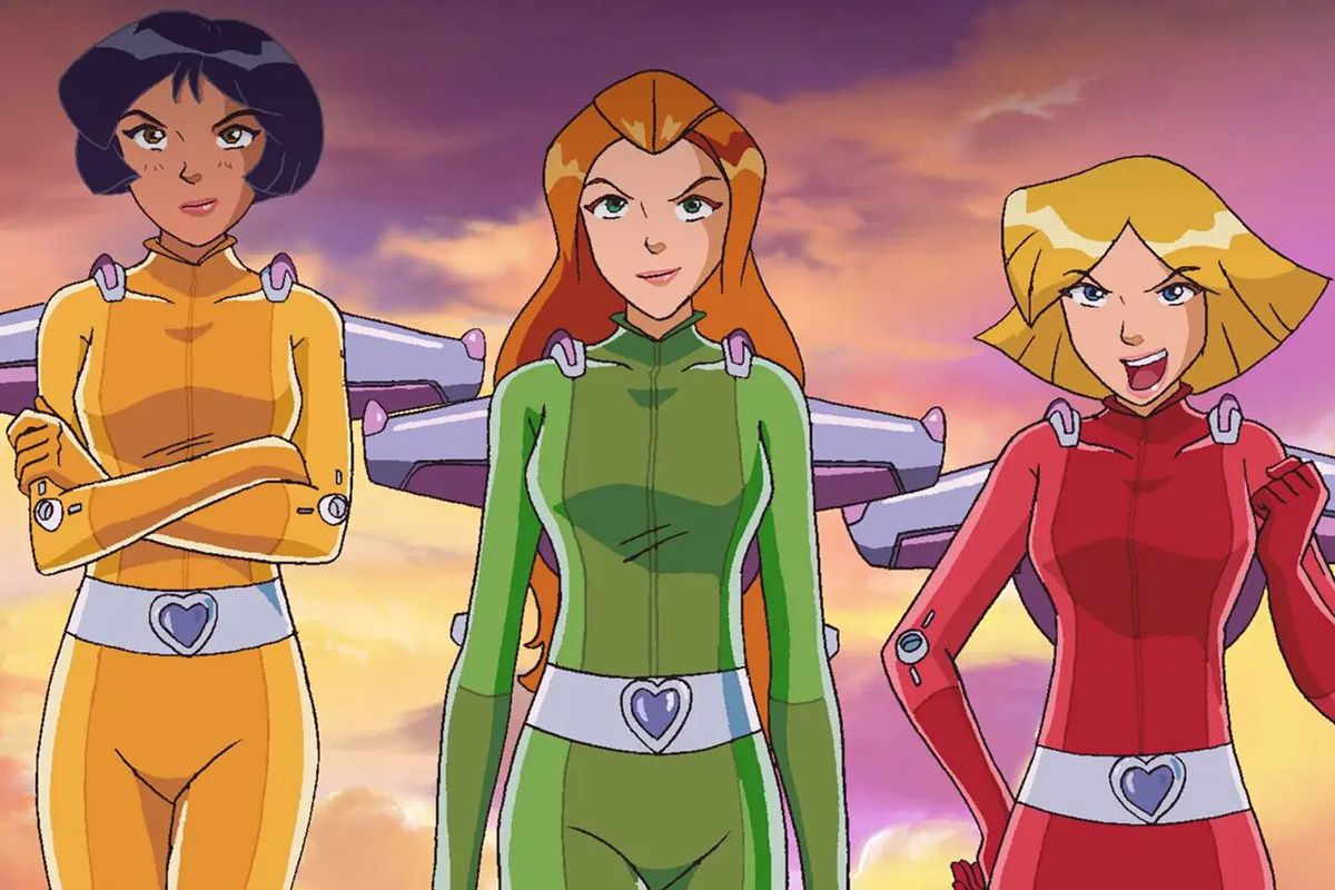 Three girls in yellow, green, and red matching jumpsuits flying side-by-side with jetpacks.