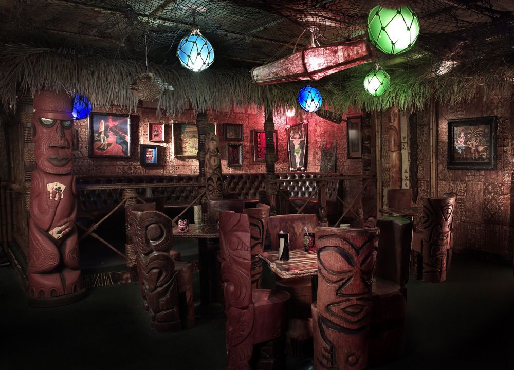 A dark bar with tiki decor