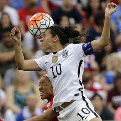 FILE - In this Feb. 21, 2016, file photo, United States’ Carli Lloyd (10) and Canada's Desiree Scott (11)  go up for a header during the first half of the CONCACAF Olympic women's soccer qualifying championship final in Houston. Five players from the World Cup-winning U.S. national team have accused the U.S. Soccer Federation of wage discrimination in an action filed with the Equal Employment Opportunity Commission. Alex Morgan, Carli Lloyd, Megan Rapinoe, Becky Sauerbrunn and Hope Solo maintain in the EEOC filing they were payed nearly four times less than their male counterparts on the U.S. men's national team. The filing was announced in a press release on Thursday, March 31, 2016. 