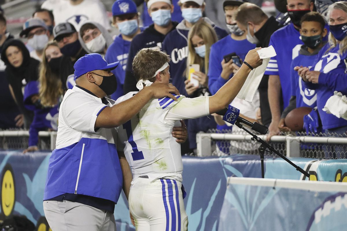 Brigham Young Cougars head coach Kalani Sitake and Brigham Young Cougars quarterback Zach Wilson (1) celebrate the win over the UCF Knights with fans during the Boca Raton Bowl in Boca Raton, Fla., on Tuesday, Dec. 22, 2020. BYU won 49-23.