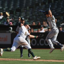 OAKLAND, CALIFORNIA - SEPTEMBER 22: Stephen Vogt #21 of the Oakland Athletics gets the out at first base of Sam Haggerty #0 of the Seattle Mariners in the top of the eighth inning at RingCentral Coliseum on September 22, 2022 in Oakland, California.