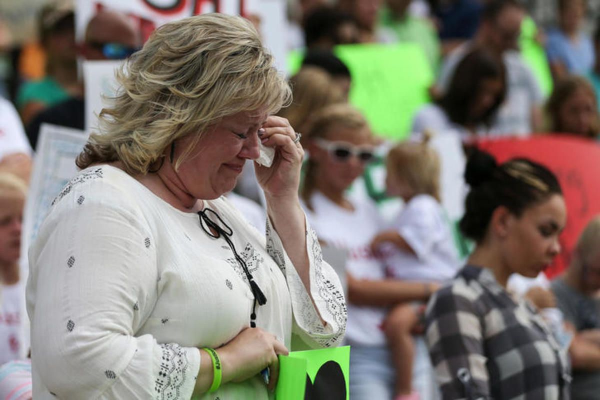 FILE: Laurie Holt, mother of Josh Holt, cries during a prayer at a rally the Capitol in Salt Lake City on Saturday, July 30, 2016. 