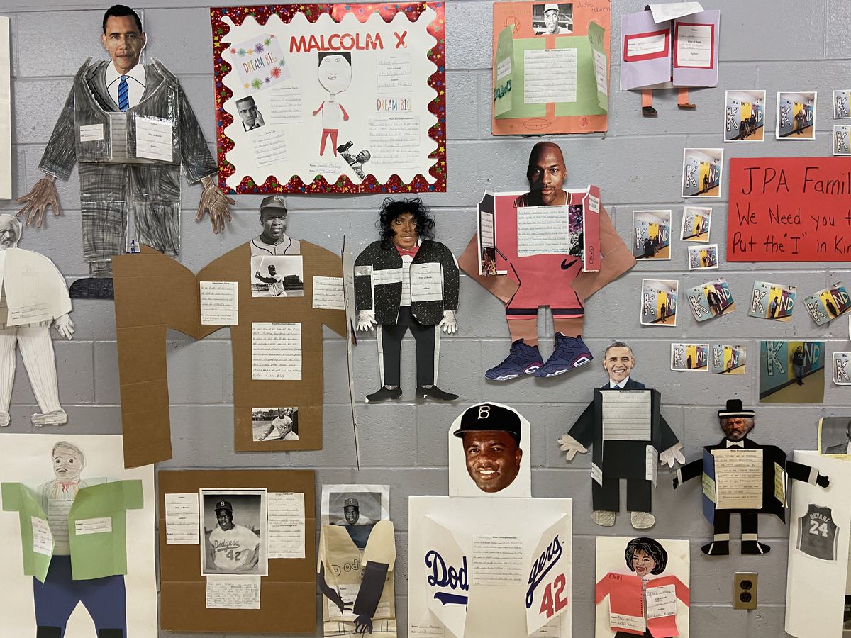A wall displaying student biography projects at Juniata Park Academy.