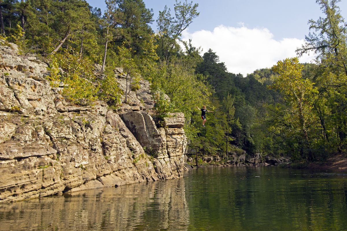Boy jumps in the Buffalo River at the Ozark National Forest Park, Arkansas, USA
