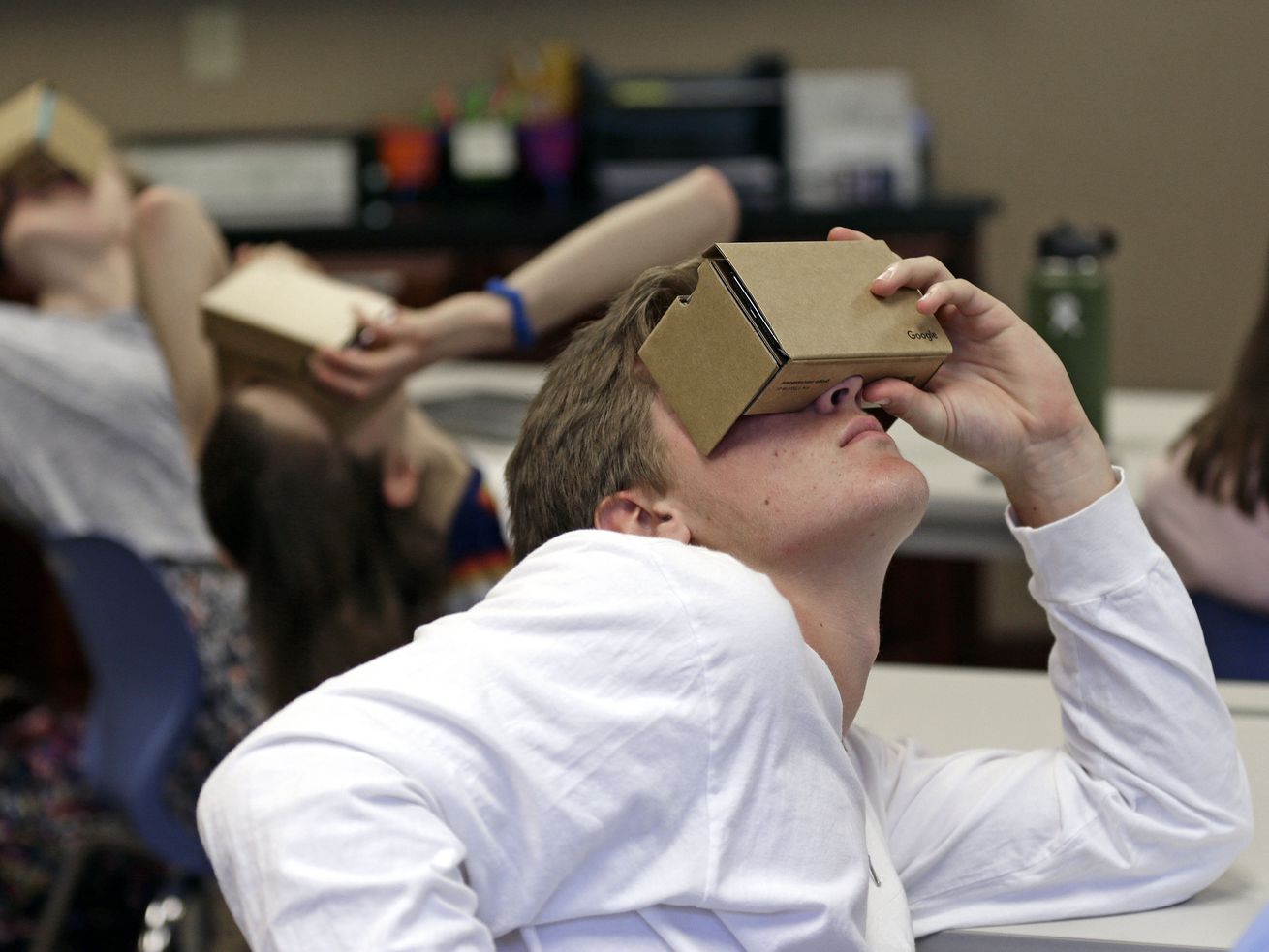 In this photo taken Tuesday, May 21, 2019, Zane Taylor and other students use virtual reality technology to learn about the D-Day invasion at Normandy during a history class at Crossroads FLEX school in Cary, N.C. In the North Carolina classroom, students learn about spies, the deadly military practice before D-Day and a general who kept his plans “on the down low.” 