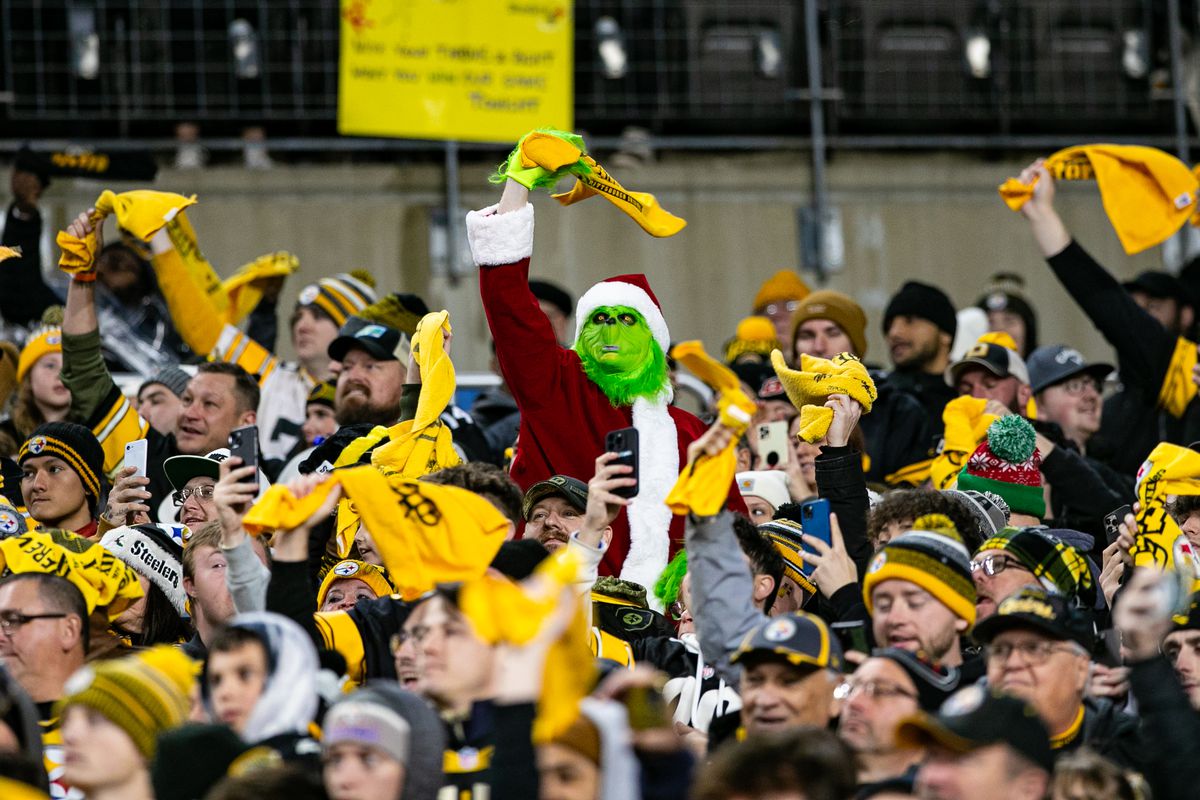 A Pittsburgh Steelers fan dressed as the grinch waves a terrible towel in the crowd during the regular season NFL football game between the Cincinnati Bengals and Pittsburgh Steelers on December 23, 2023 at Acrisure Stadium in Pittsburgh, PA.
