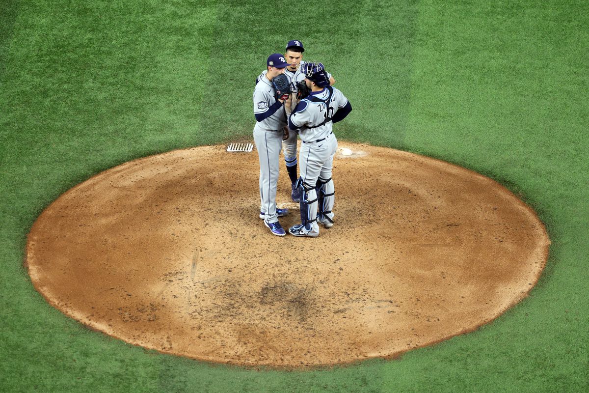 Blake Snell #4 of the Tampa Bay Rays receives a mound visit against the Los Angeles Dodgers during the fifth inning in Game Two of the 2020 MLB World Series at Globe Life Field on October 21, 2020 in Arlington, Texas.