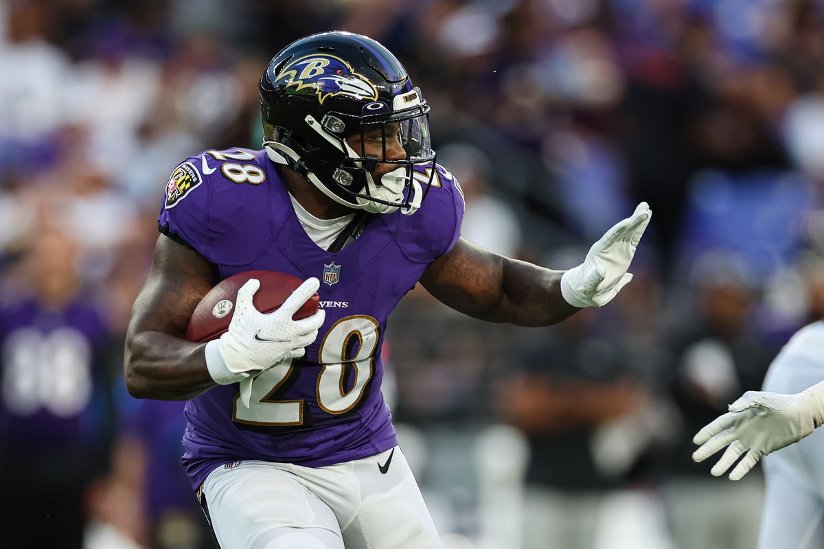BALTIMORE, MD - AUGUST 27: Mike Davis #28 of the Baltimore Ravens carries the ball against the Washington Commanders during the first half of a preseason game at M&amp;T Bank Stadium on August 27, 2022 in Baltimore, Maryland.