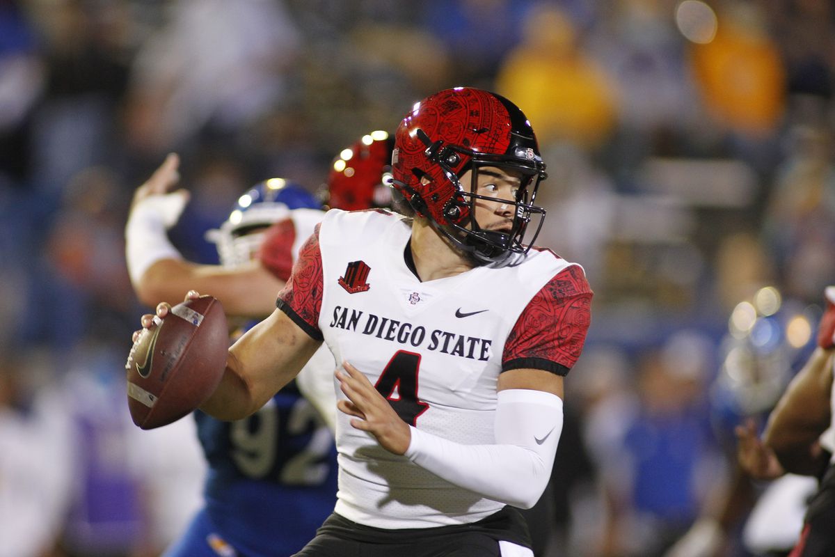 San Diego State Aztec QB Jordon Brookshire (4) drops under a heavy pass rush in the game between the San Diego State Aztecs and the San Jose State Spartans on October 15, 2021, at CEFCU Stadium in San Jose, CA.