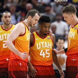Utah Jazz forward Joe Ingles (2), guard Donovan Mitchell (45) and forward Jonas Jerebko (8) gather on the court during the game against the Golden State Warriors at Vivint Arena in Salt Lake City on Tuesday, Jan. 30, 2018.