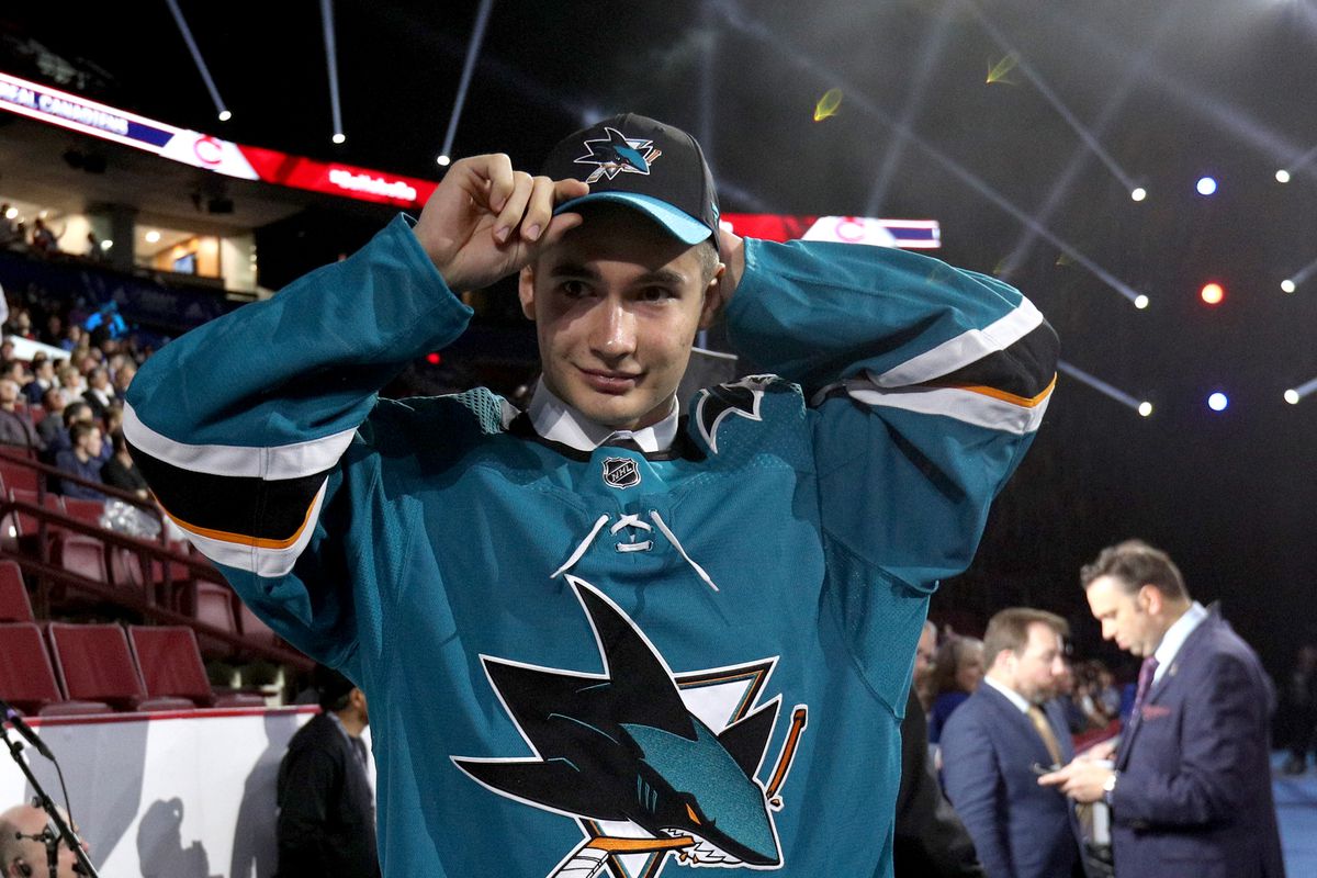 Artemi Kniazev, 48th overall pick of the San Jose Sharks, puts on a team hat during Rounds 2-7 of the 2019 NHL Draft at Rogers Arena on June 22, 2019 in Vancouver, Canada.