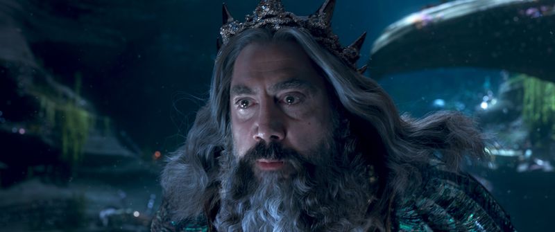 Javier Bardem as King Triton, his hear and beard thick and long and his face grim.