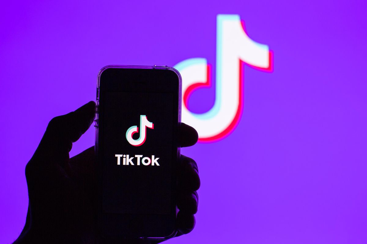 In this photo illustration, a Tik Tok app seen displayed on...