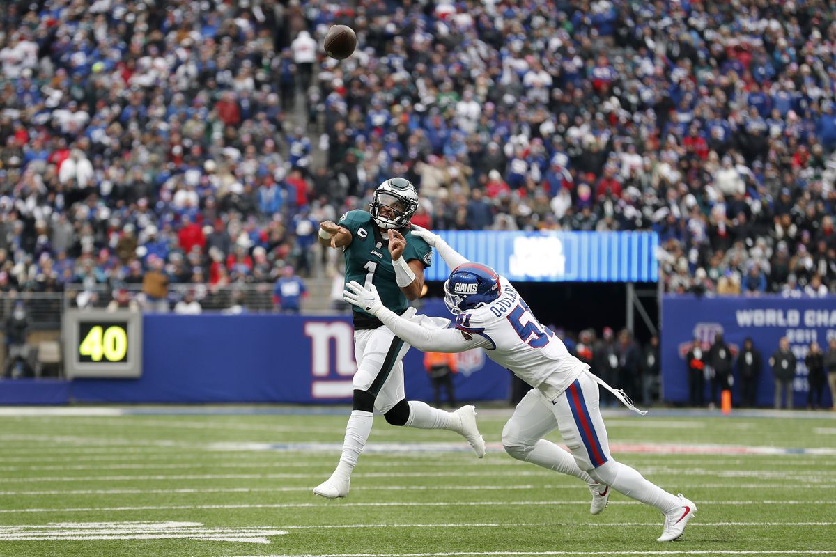 Jalen Hurts #1 of the Philadelphia Eagles in action against Azeez Ojulari #51 of the New York Giants at MetLife Stadium on November 28, 2021 in East Rutherford, New Jersey. The Giants defeated the eagles 13-7.