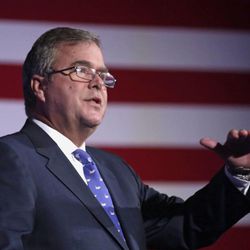 FILE - In this Aug. 9, 2013 file photo, former Florida Gov. Jeb Bush speaks in Chicago.  To say that new academic standards have yielded strange bedfellows would be an understatement. Republican-on-Republican infighting? Teacher unions linking arms with tea partyers? President Barack Obama working in tandem with the U.S. Chamber of Commerce and energy giant Exxon? When it comes to Common Core, forget the old allegiances. Traditionally Democratic-leaning groups donâ??t like the standardized tests and are finding allies among small-government conservatives. The Obama administration wants more students leaving high school ready for college courses or their first jobs, a goal shared by big corporations. (AP Photo/M. Spencer Green, File)