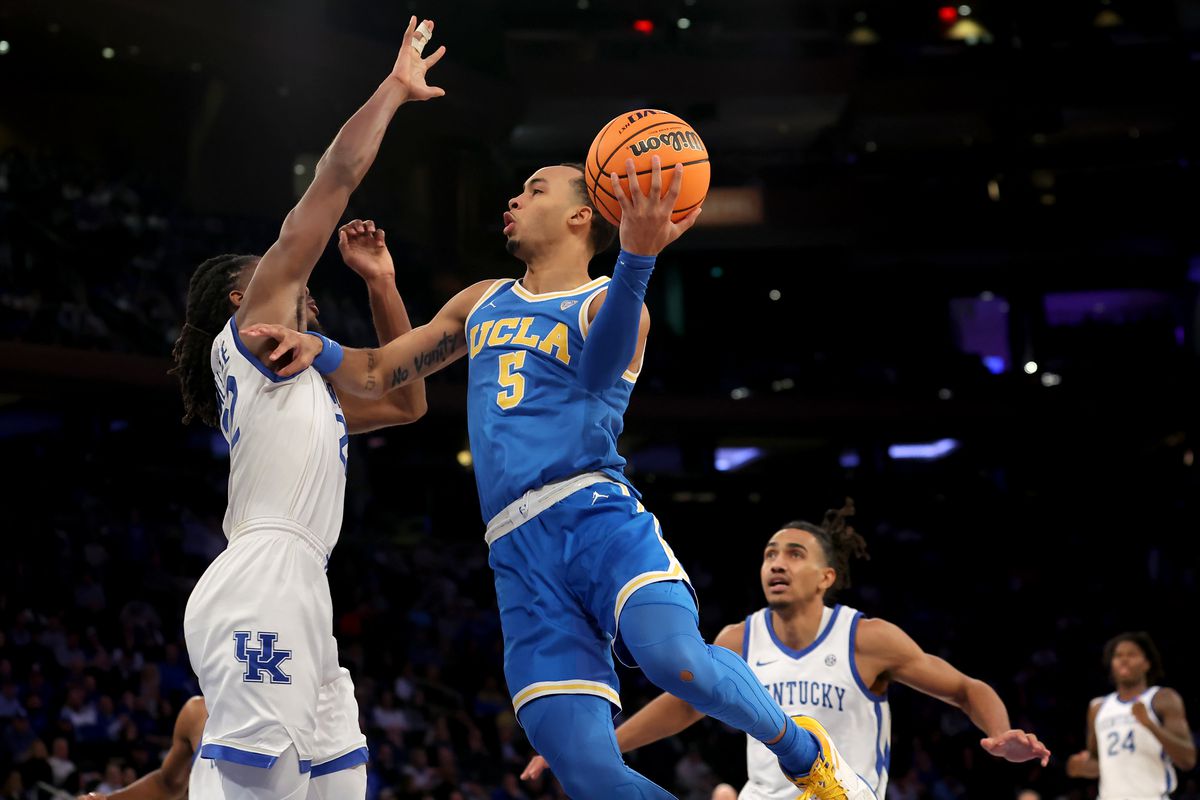 UCLA Bruins guard Amari Bailey drives to the basket against Kentucky Wildcats guard Cason Wallace and forward Jacob Toppin during the second half at Madison Square Garden.