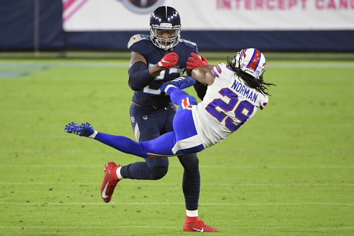 Tennessee Titans running back Derrick Henry throws Buffalo Bills cornerback Josh Norman to the side from a stiff arm during the first half at Nissan Stadium.