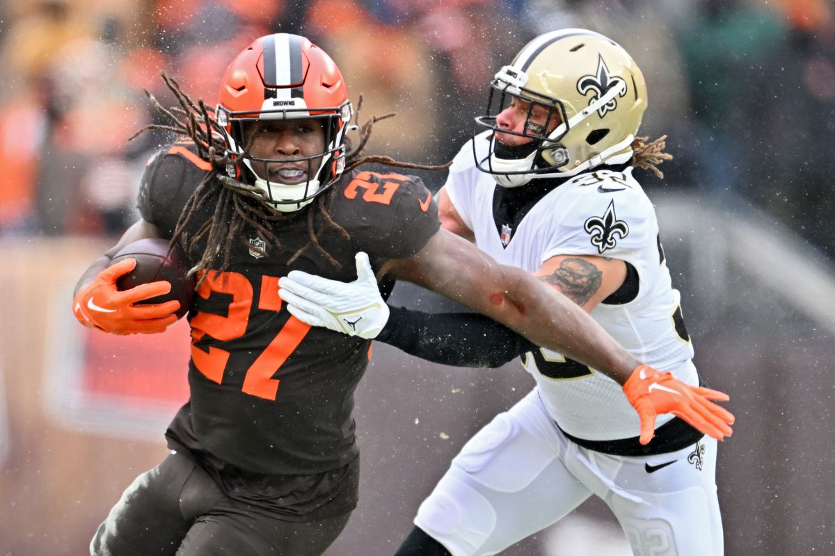 CLEVELAND, OHIO - DECEMBER 24: Kareem Hunt #27 of the Cleveland Browns is tackled by Tyrann Mathieu #32 of the New Orleans Saints during the first half at FirstEnergy Stadium on December 24, 2022 in Cleveland, Ohio.
