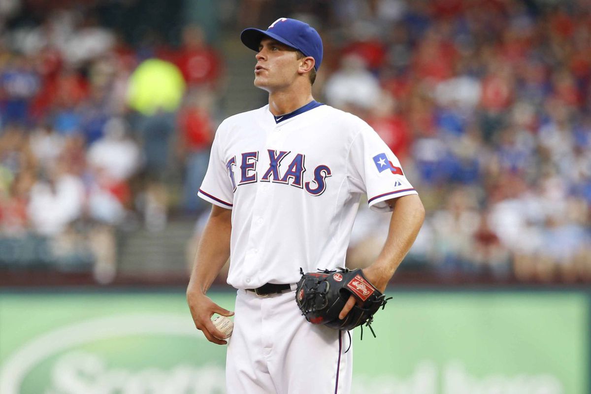 June 25, 2012; Arlington, TX, USA; Texas Rangers starting pitcher Justin Grimm (51) pauses on the mound during the first inning against the Detroit Tigers at Rangers Ballpark in Arlington. Mandatory Credit: Jim Cowsert-US PRESSWIRE