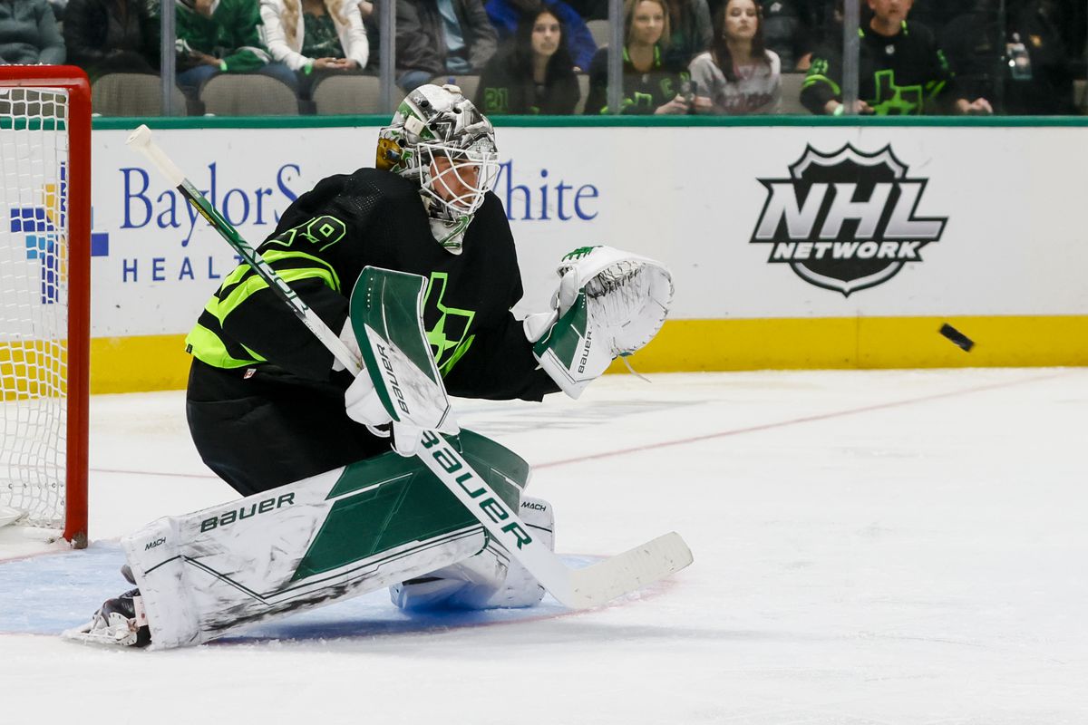 Dallas Stars goaltender Jake Oettinger (29) blocks a shot during the game between the Dallas Stars and the San Jose Sharks on December 31, 2022 at American Airlines Center in Dallas, Texas.