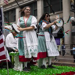 Members of the Amici Italiani Dance Troupe in Rockford perform on a float at the Columbus Day Parade as it moves down North State Street in the Loop, Monday afternoon, October 11, 2021.