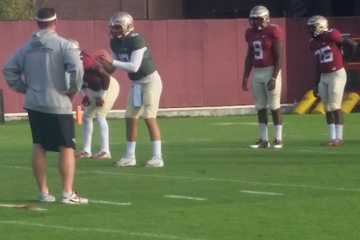 Sean Maguire and Dalvin Cook working at practice while Jacques Patrick and Jonathan Vickers watch.
