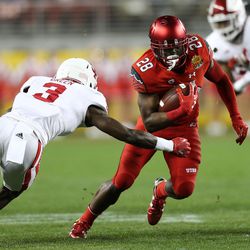 Utah Utes running back Joe Williams (28) puts a move on Indiana Hoosiers defensive back Tyler Green (3) as the Utes and the Hoosiers play in the Foster Farms Bowl in Santa Clara, California, on Wednesday, Dec. 28, 2016.