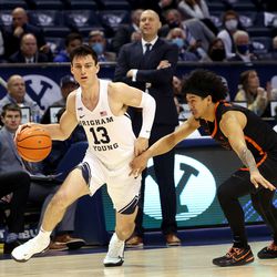 Brigham Young Cougars guard Alex Barcello (13) drives around Pacific Tigers guard Pierre Crockrell II (3) as BYU and Pacific play in an NCAA basketball game in Provo at the Marriott Center on Thursday, Jan. 6, 2022. BYU won 73-51.