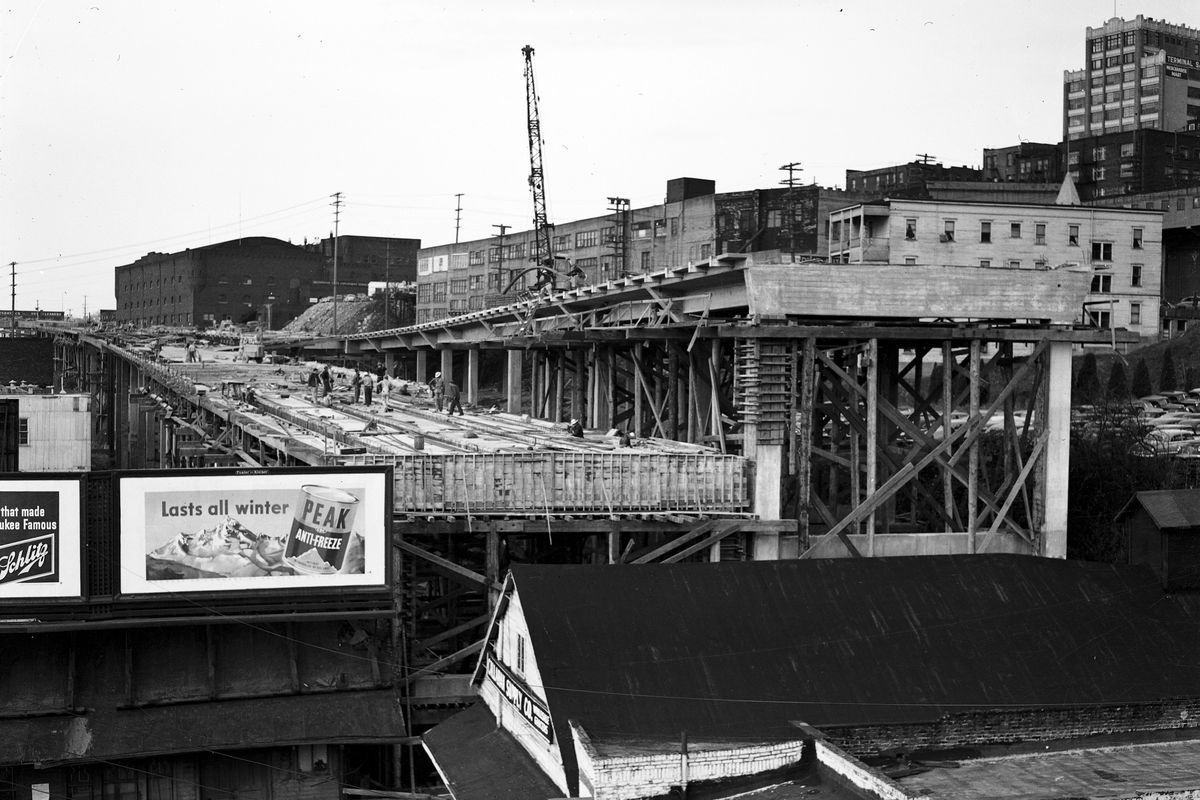 The Alaskan Way Viaduct and advertising billboards. This is a black and white photograph.