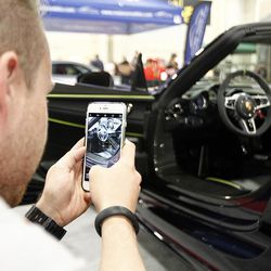 Mack Adams of Holliday takes a photo of the interior of a Porsche at the AutoRama car show at the South Towne Expo Center in Sandy on Friday, March 4, 2016.