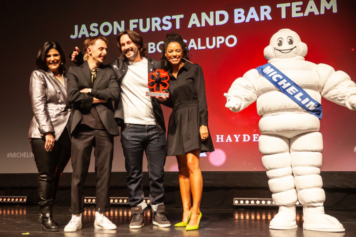 General manager of BoccaLupo Jason Furst and chef Ben Skolnick accept the award for outstanding cocktails as they pose next to the Michelin Man and with emcee Mara Davis and Michelin’s communications director Elisabeth Boucher-Anselin.