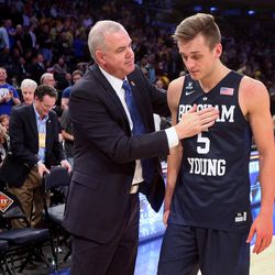 Brigham Young Cougars head coach Dave Rose consoles Brigham Young Cougars guard Kyle Collinsworth (5) after the BYU Cougars fall to Valparaiso 70-72 in NIT Semifinal action at Madison Square Garden in New York City Tuesday, March 29, 2016.