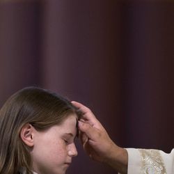 Chance Cannon, fourth-grader at the Madeleine Choir School, receives ashes during Mass on Ash Wednesday at the Cathedral of the Madeleine in Salt Lake City on Wednesday, Feb. 18, 2015.