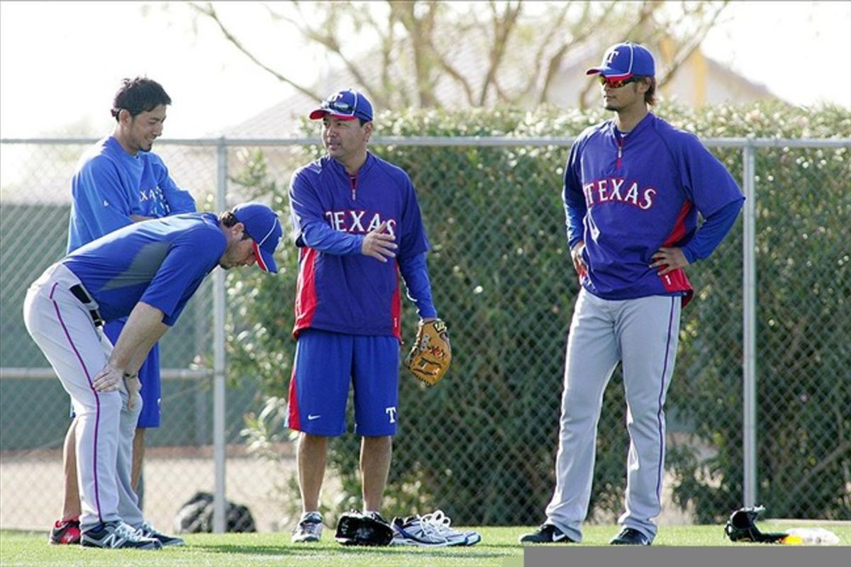 Feb 22, 2012; Surprise, AZ, USA; Texas Rangers pitcher Yu Darvish (right) during a workout at Surprise Stadium.  Mandatory Credit: Jake Roth-US PRESSWIRE