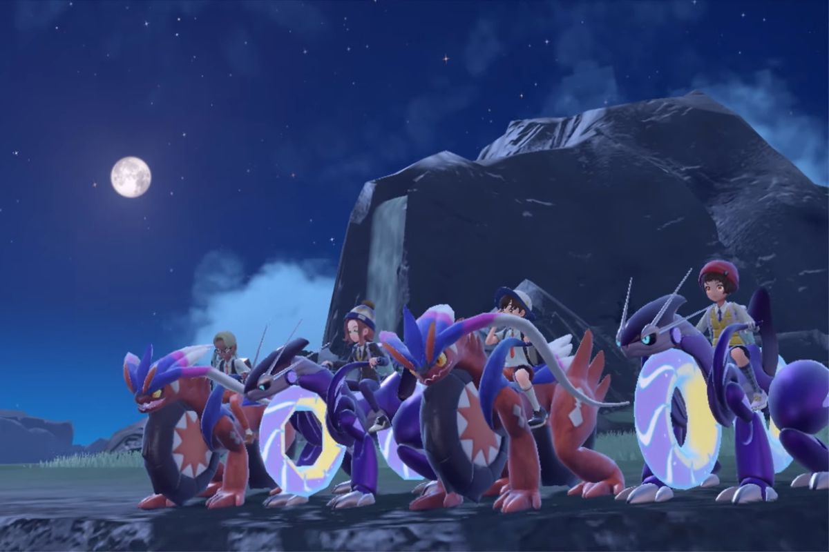 A group of four players, and each is riding a Legendary Pokémon (either Koraidon or Miraidon) in their motorcycle forms.