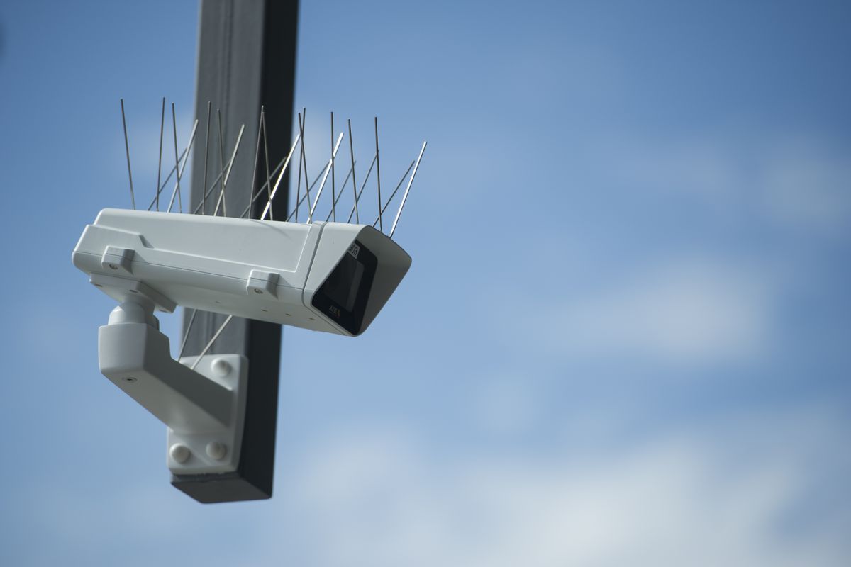 An outdoor surveillance camera with bird-discouraging spikes on it