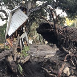 This photo provided by the Santa Barbara County Fire Department shows mud, boulders, and debris that destroyed homes that lined Montecito Creek near East Valley Road in Montecito, Calif., Wednesday, Jan. 10, 2018. Anxious family members awaited word on loved ones Wednesday as rescue crews searched grimy debris and ruins for more than a dozen people missing after mudslides in Southern California on Tuesday destroyed over a 100 houses, swept cars to the beach and left more than a dozen victims dead. (Mike Eliason/Santa Barbara County Fire Department via AP)