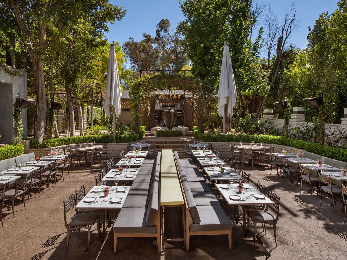 Several tables in the garden at Casaléna in Woodland Hills.