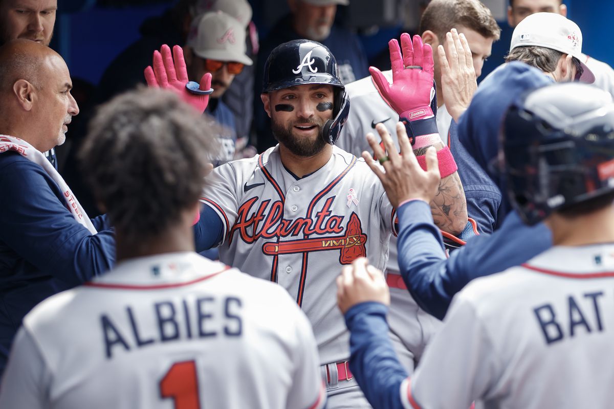 Kevin Pillar of the Atlanta Braves celebrates a solo-home run in the dugout during the fourth inning of their MLB game against the Toronto Blue Jays at Rogers Centre on May 14, 2023 in Toronto, Canada.