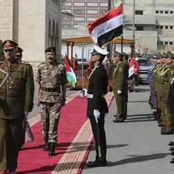 The Chairman of the Joint Chiefs of Staff of the Jordanian armed forces, Lt. Gen. Mashal al-Zaben, center, inspects a guard of honor during a welcome ceremony at the Iraqi defense minister headquarters in Baghdad, Iraq, Wednesday, Feb. 11, 2015. Al-Zaben met with Iraqi Defense Minister Khalid al-Obeidi and reiterated Jordan's "support to Iraq in its war against the terrorist gangs," according to an official statement. 