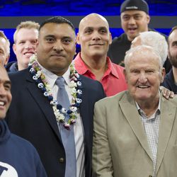 Former players and former head coach LaVell Edwards pose for photos with new head coach Kalani Sitake, following a press conference in Provo Monday, Dec. 21, 2015.