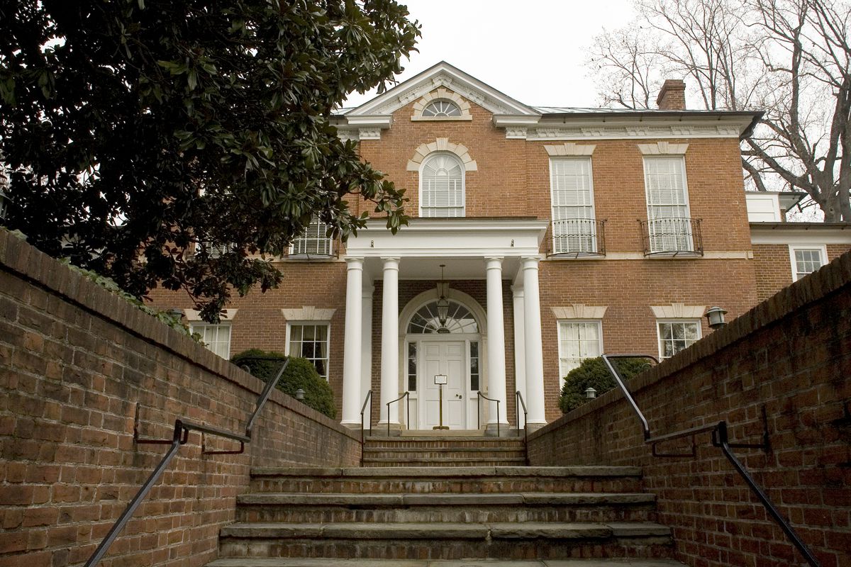 Dumbarton House, a Federal style building in Georgetown, as seen from the front. There are stairs leading up to the brick facade and white columns.