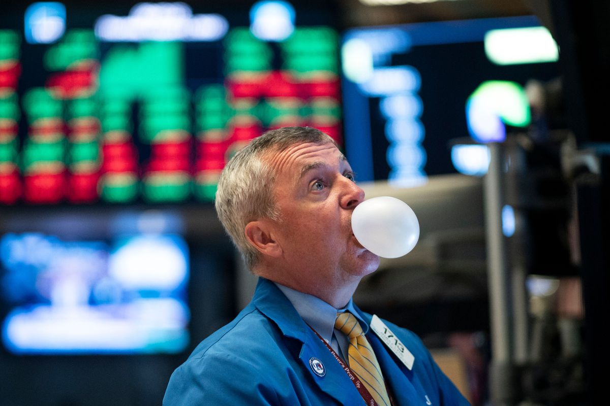 A stock trader blowing bubble gum on the trading floor.