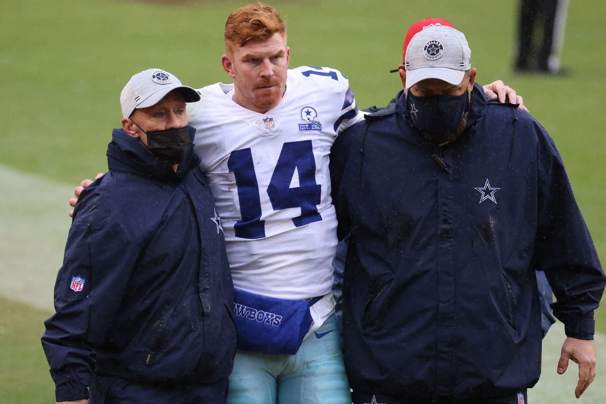Dallas Cowboys quarterback Andy Dalton (14) is helped to the locker room after being knocked out of the game on a hit by Washington Football Team inside linebacker Jon Bostic (not pictured) in the third quarter at FedExField. Mandatory Credit: Geoff Burke