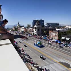 Emma Lopez, 17, watches the Freedom Festival’s July 4th Grand Parade from atop a wing of the Zions Bank Financial Center in Provo on Wednesday, July 4, 2018.
