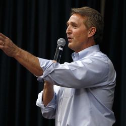 Arizona Republican Sen. Jeff Flake takes a question from the audience during a town hall Thursday, April 13, 2017, in Mesa, Ariz. Flake is holding his first public event with constituents since January after coming under withering criticism for his voting record and avoiding such gatherings in recent months. (AP Photo/Ross D. Franklin)